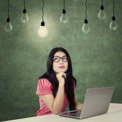 Worker thinking idea under light bulb