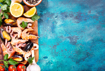 seafood with fresh vegetables on blue background