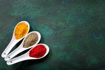 Keuken spatwand met foto various spices in a ceramic spoons © Nitr