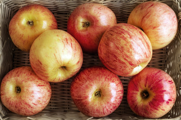 Ripe red apples on wooden background