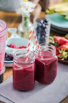 Two jars with berry smoothie