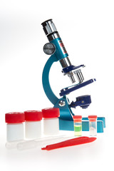 Laboratory metal microscope and test tubes with liquid isolated on white