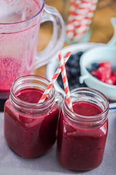 Two jars with berry smoothie