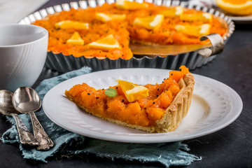 Piece of pumpkin tart with orange