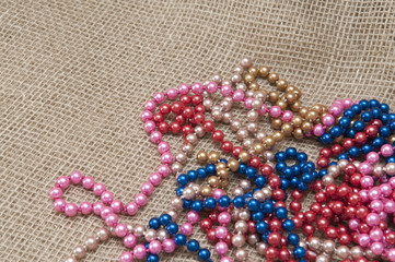 Multi-colored beads on a background fabric