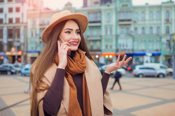 Young people and technology. Happy young pretty woman with phone walking down the street. Vacation Europe