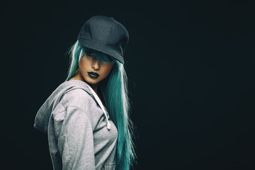 Young woman in hoodie and cap