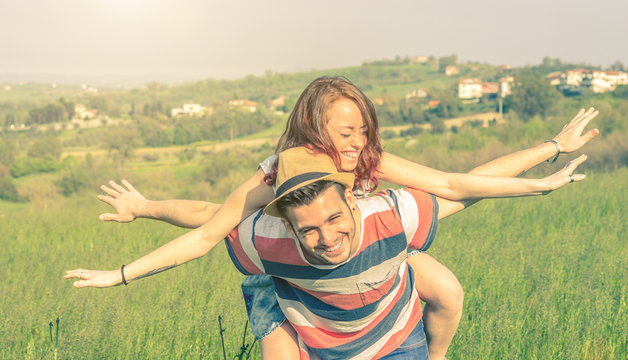 Couple in love having fun doing the airplane 