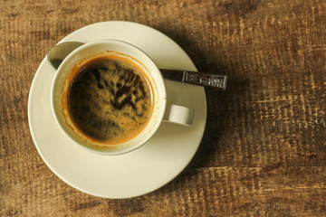 Top view of coffee cup on wooden table