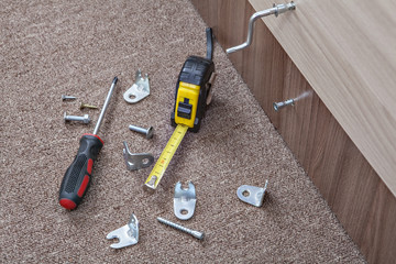 Furniture screws with crosshead screwdriver, tape measure, Hardware and Fasteners. 