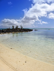 Fototapeta na wymiar Black stones in the sea. Mauritius