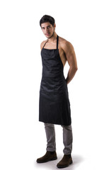 Fototapeta premium Young sexy shirtless chef or waiter wearing only apron