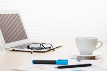 Office workplace with with laptop and coffee