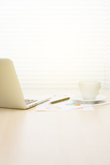Office workplace with with laptop and coffee