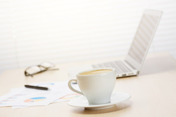 Office workplace with with laptop and coffee