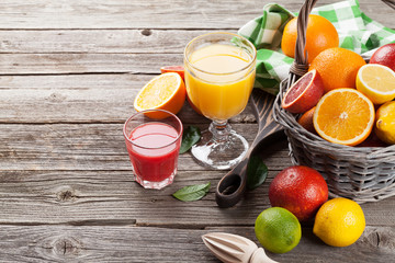 Fresh ripe citruses and juice. Lemons, limes and oranges