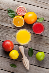 Fresh ripe citruses and juice. Lemons, limes and oranges