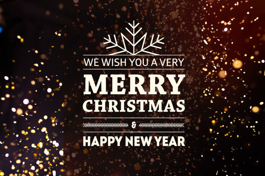 Photo of golden glitter on a black background with Merry Christmas and Happy New Year lettering 