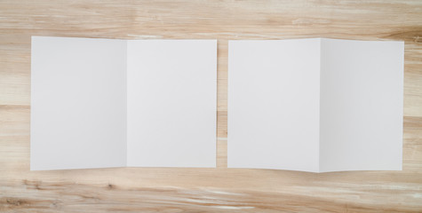 Bifold white template paper on wood texture