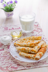 Breakfast. Pancakes, glass of milk, honey and sour cream
