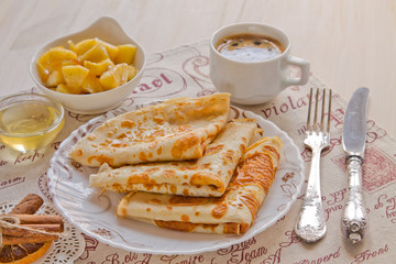 Breakfast. Pancakes, a cup of black coffee, honey and apples flambé