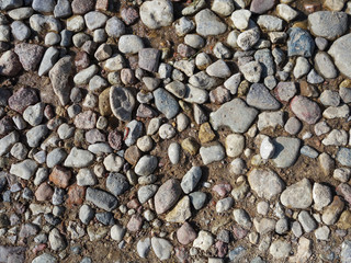 Stones of different shapes on the wet ground