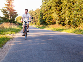 Obraz premium Evening journey. Man riding a bike
