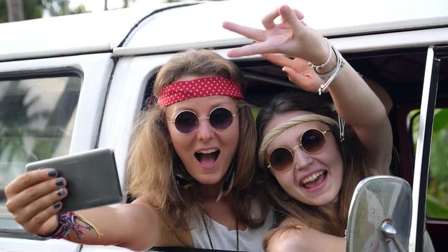 Young Cute Hippie Girls Having Fun Doing Selfie in Retro Bus