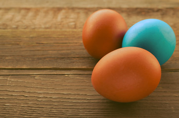 Painted colorful easter eggs on rustic wooden background