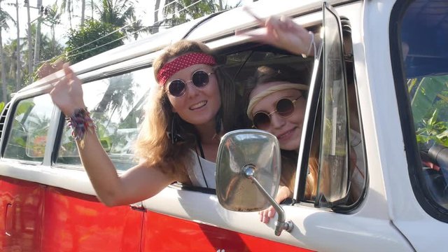 Hippie Girls Travel in Van on a Road Trip with Peace Sign
