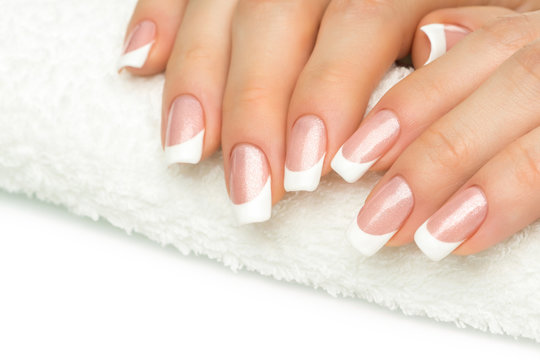 Beautiful fingers with french manicure on the towel. Manicure in