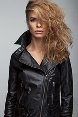 Fototapeta na wymiar Fashion shoot of girl with beautiful hair style in a leather jacket