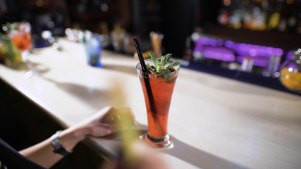 Beautiful red cocktail on the bar.