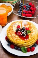 Pancakes with berries and maple syrup