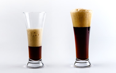 Pouring process of dark stout beer into a beer glass, splashes, drops and froth around glass
