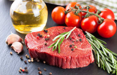raw steak with cooking ingridients