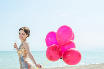 woman with balloons on the sea