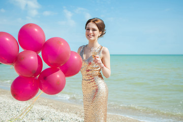 woman with balloons on the sea