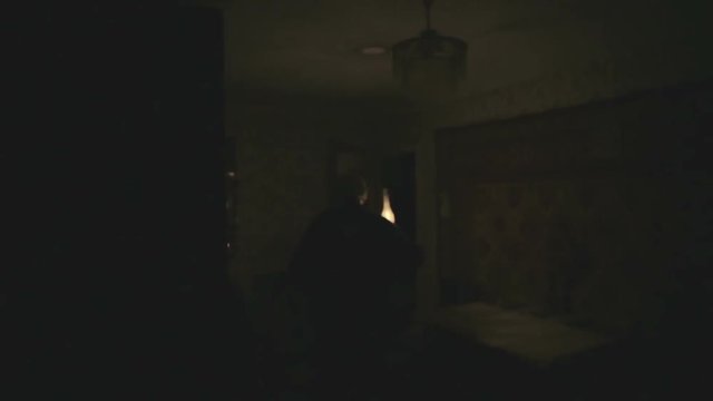 Old grandpa is a dark room with a kerosene lamp. Scary ghost in the night.