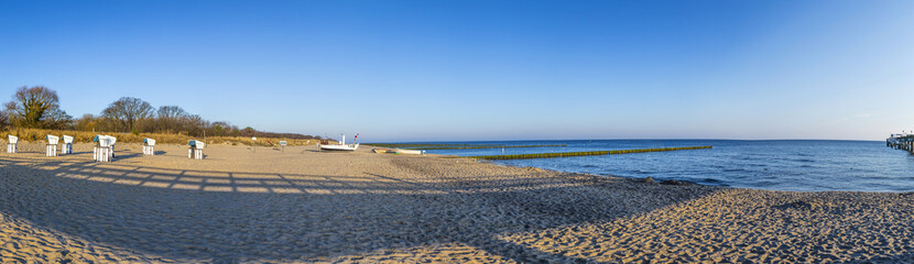 beach in the morning with beach chairs and fisher boat