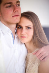 Happy woman dressed in  shirt put her head on shoulder of man