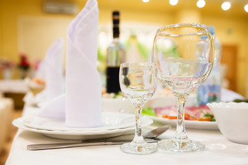 Restaurant table with glasses, napkins and cutlery