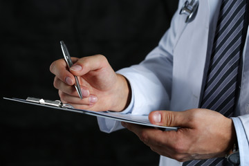 Fototapeta Male medicine doctor hand holding silver pen writing obraz