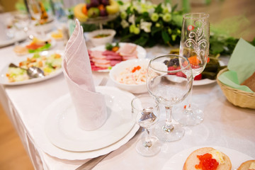 Restaurant table with glasses, napkins and cutlery