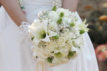white flower on bride hand