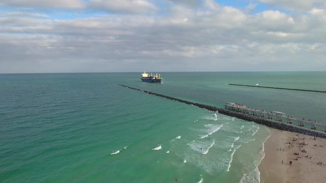 Aerial video of a cargo ship entering Port Miami through Government Cut
