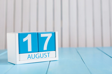 August 17th. Image of august 17 wooden color calendar on blue background. Summer day. Empty space for text
