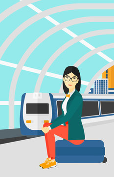 Woman sitting on railway platform.