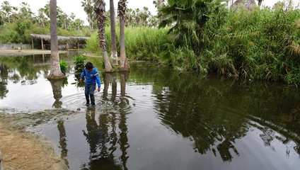 Fototapeta na wymiar Child playing in flooded water in Mexico