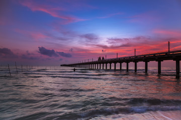 Fototapeta na wymiar Silhouette morning sunrise over sea pier in Thailand